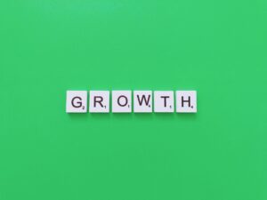 Scrabble tiles spell the word "GROWTH" on a green background, symbolizing how strategies like SEO for Business Growth can help elevate your brand.